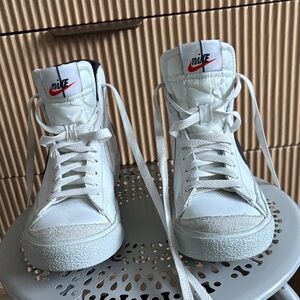 Nike White High-Top Sneakers with Red Swoosh Logo